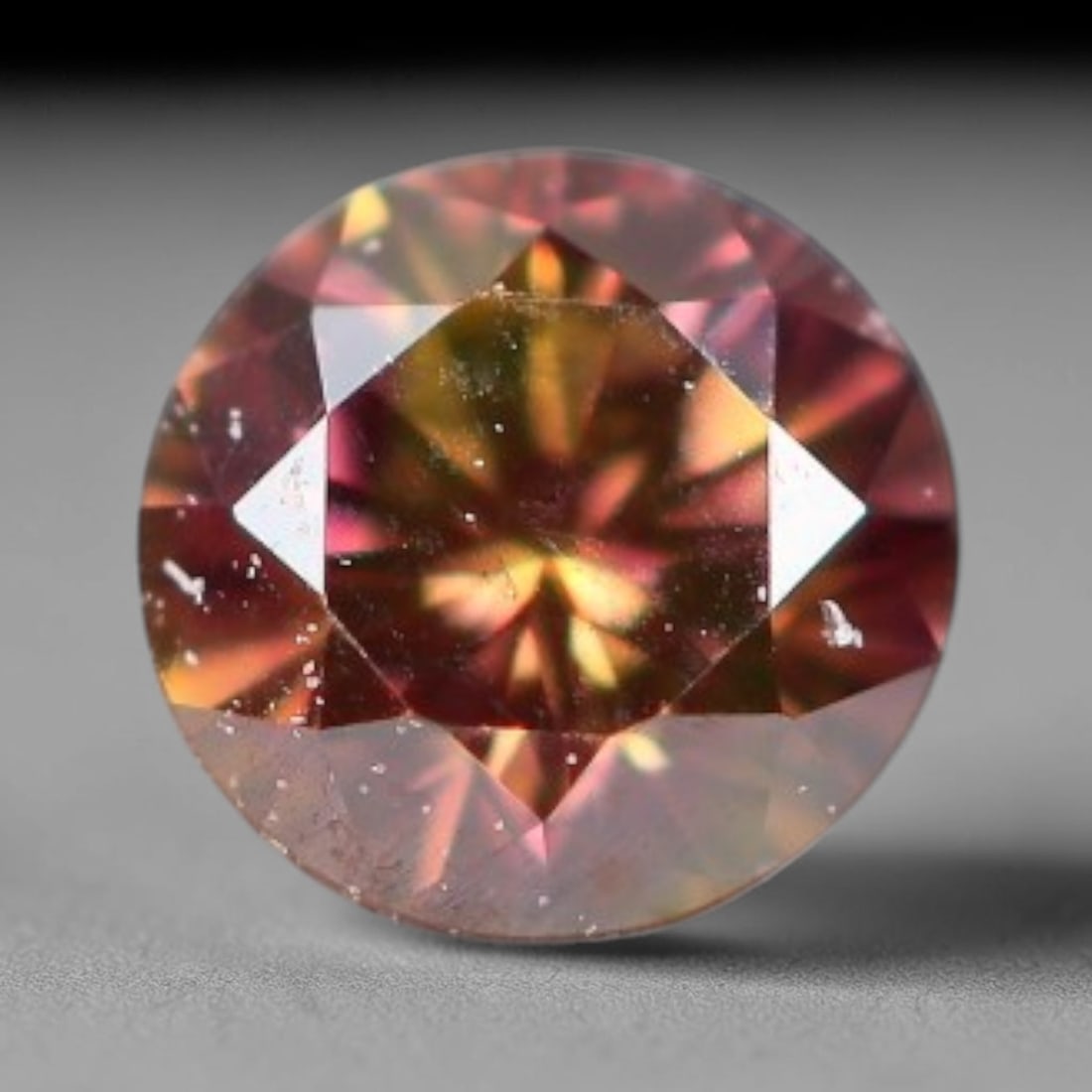 0.09ct Natural Fancy Pinkish Purple Diamond Loose Gemstone, 8BH: This polished natural diamond displays rich pinkish-purple body saturation, with subtle fine microscopic mineral specks distributed within its crystal interior, measured at calibrated dimensions of 2.