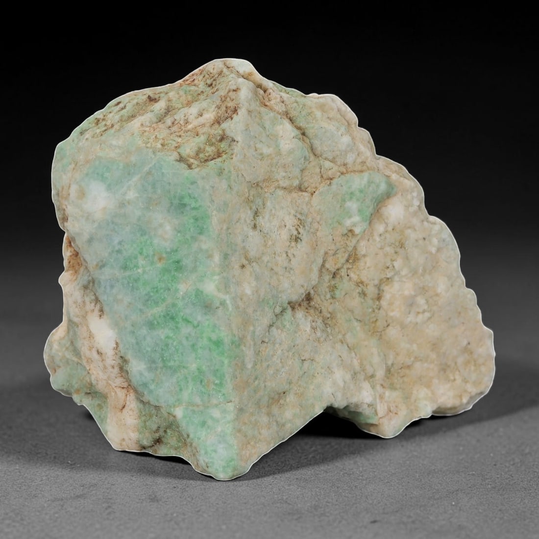 1120ct Natural Burmese Light Green Jadeite Rough - Raw Earthy Toned Stone, 70EA: This is a natural Type A Burmese jadeite rough stone, measuring 8.3x6.3cm and weighing 1120ct. It features soft, natural light green formations set against a muted off-white and earthy-toned base, cre