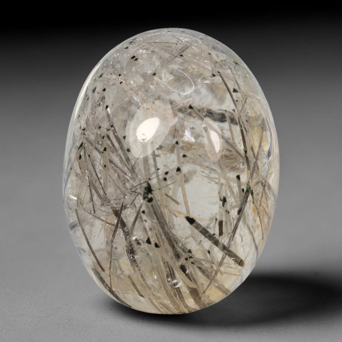 55ct Natural Brazilian Black Rutile Quartz Cabochon Loose Gemstone, 42BM: This polished cabochon of natural rutile quartz features countless distinct slender black rutile needle inclusions suspended within the clear quartz host crystal. The smooth domed surface enables full