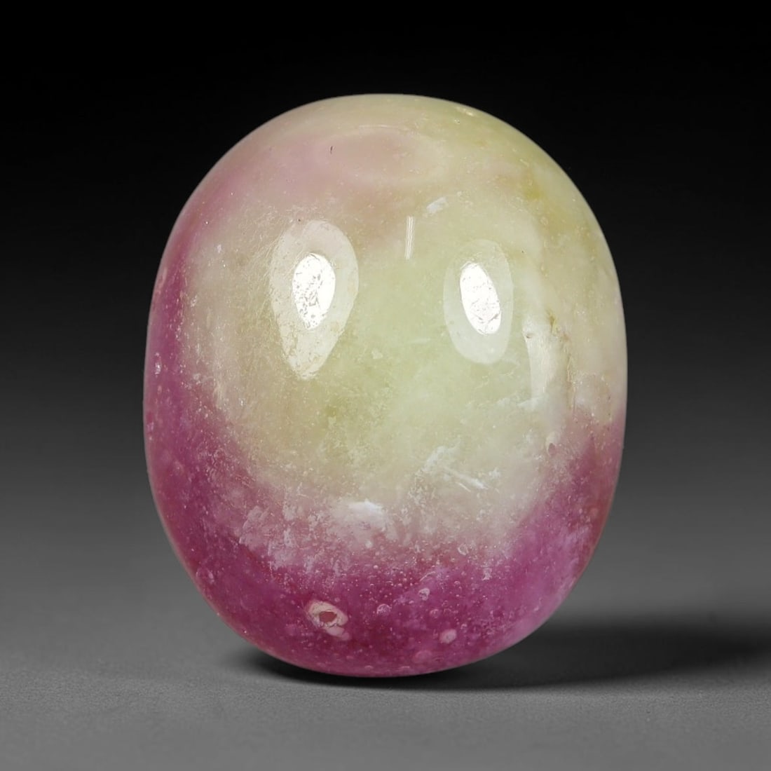 17.20 Carats Natural Mozambique Bicolor Ruby Loose Gemstone, 49FG: This natural Mozambique bicolor ruby cabochon holds dimension measurements of 15.6x13.1x7.4mm, displaying soft swirled intermix of rich pink and pale creamy mineral tones that blend seamlessly across 