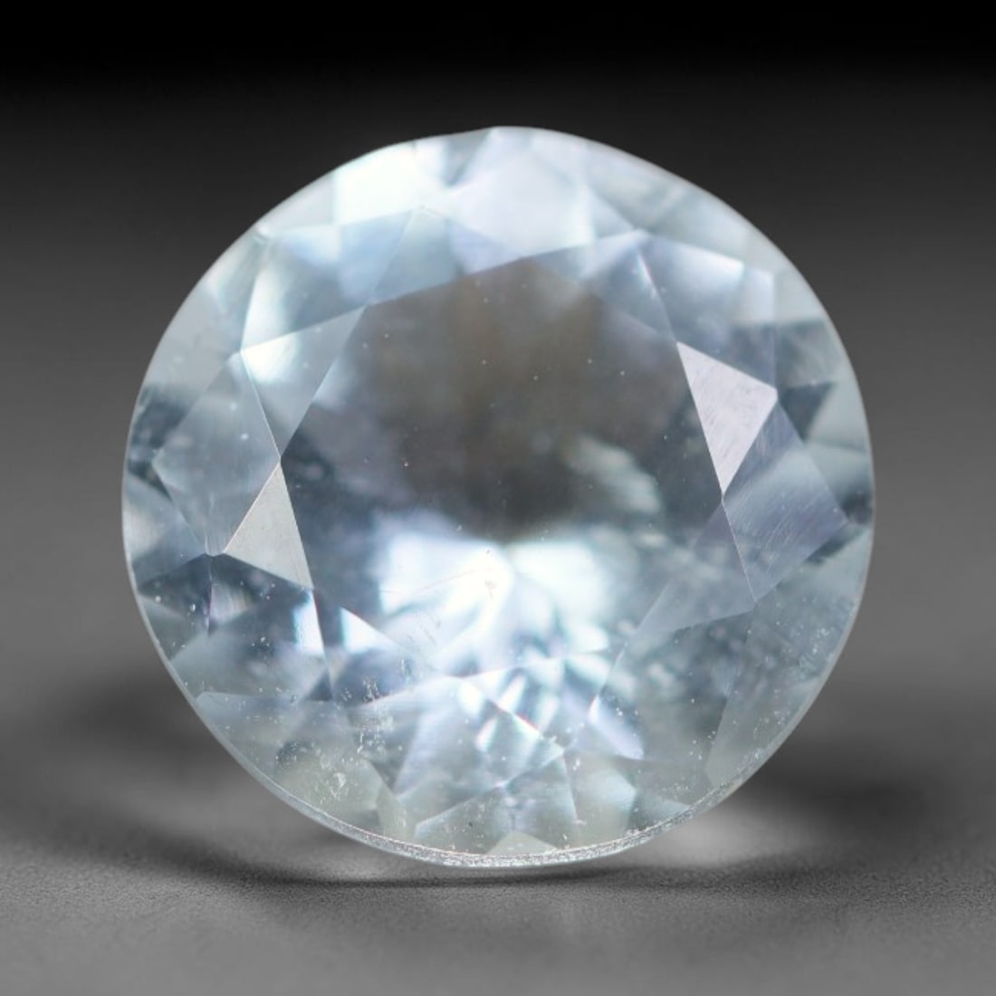2.16ct Natural Brazilian Sky Blue Faceted Aquamarine Loose Gemstone, 24BC: This precisely faceted aquamarine boasts clear translucent pale sky blue body tone with subtle thin mineral needle and tiny scattered crystalline specks visible within its polished reflective planes i