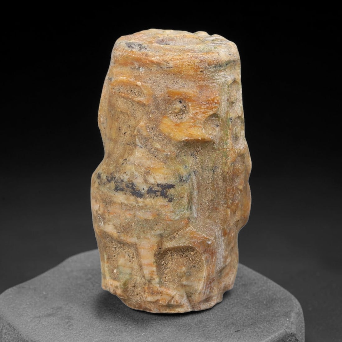 Ancient Mesopotamian Banded Calcite Figural Zoomorphic Cylinder Seal (2900-2334 BCE), 76AB: Barrel-shaped banded calcite cylinder seal with full longitudinal central bore for cord suspension. The exterior is carved in relief with stylised avian zoomorphic motifs across all sides, layered war