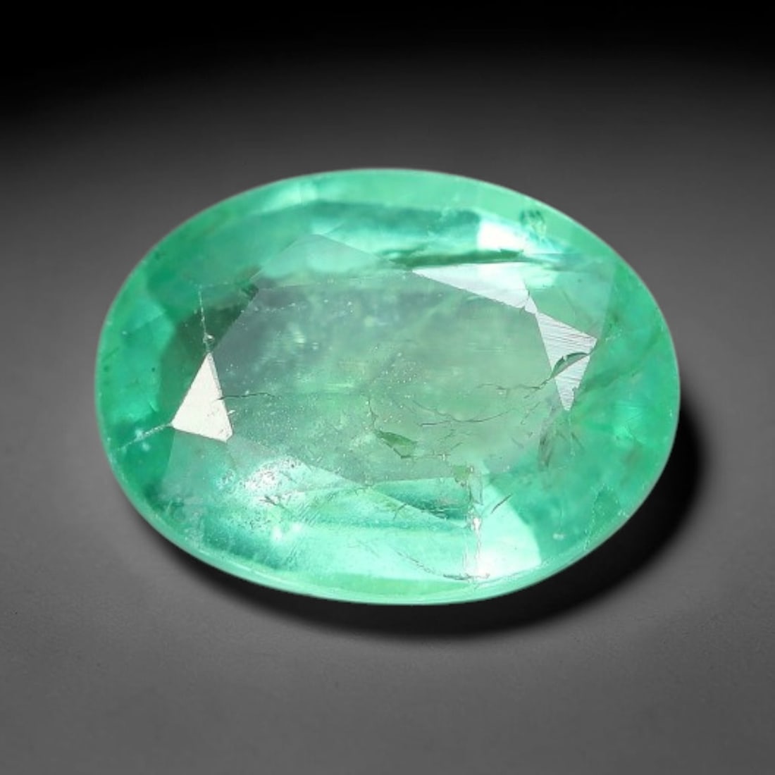 0.91 Carats Natural Zambian Green Emerald Loose Gemstone, 46AH: This green Zambian emerald holds smooth even saturation with subtle faint natural internal markings lending authentic organic character, measured at 7.4x5.5x3.2mm, its calm cool green tone delivers un