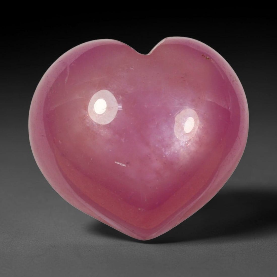 14.98ct Natural Mozambique Hot Pink Ruby Loose Gemstone, 77BP: This heart shaped Mozambique ruby cabochon measures 14x12.8x7.2mm, showcasing a vivid saturated hot pink body paired with stunning natural hexagonal crystal growth banding that forms a distinct geomet