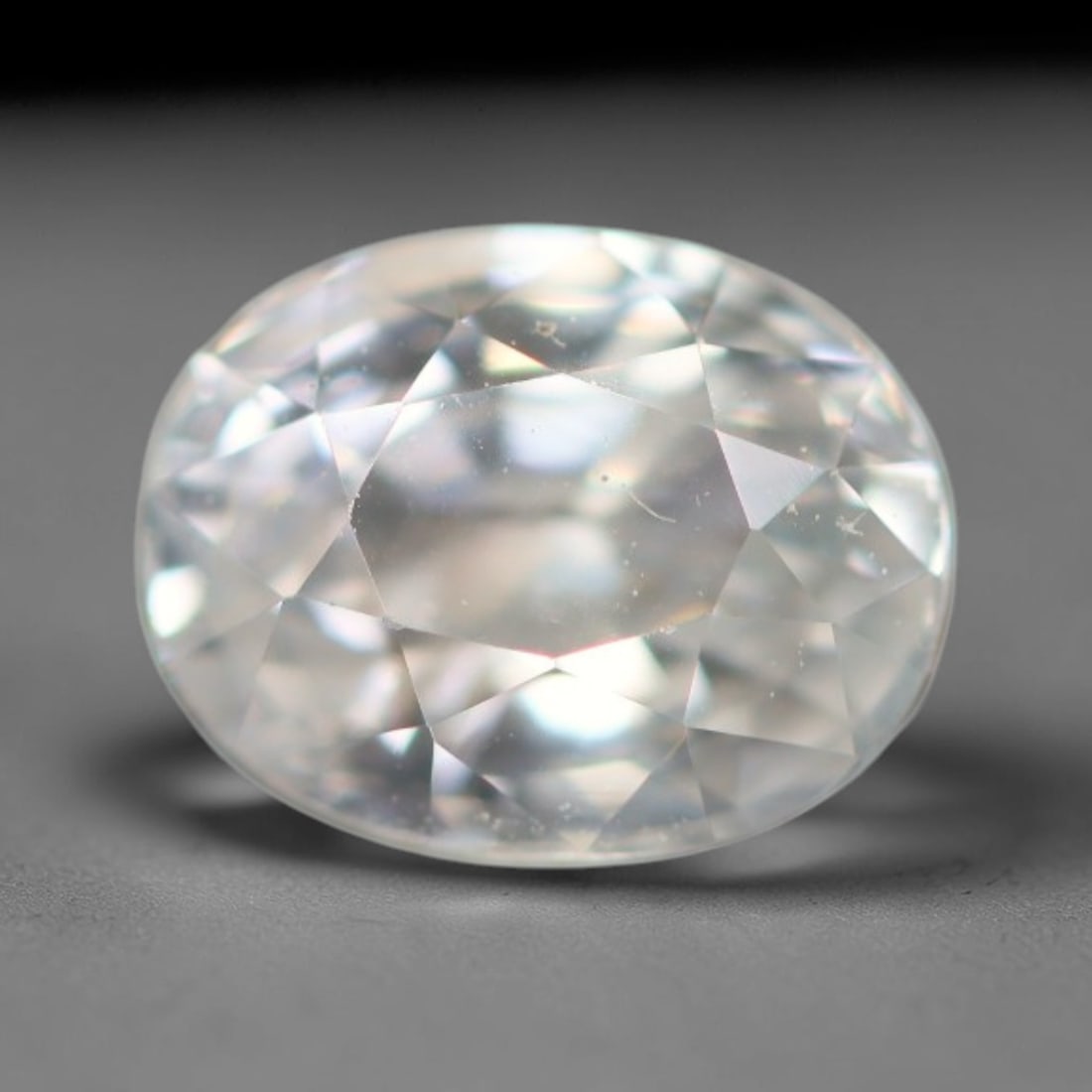 1.24ct Natural Cambodian White Zircon Loose Gemstone, 24BA: This fully polished Cambodian white zircon displays a crisp colorless transparent crystal body with faint microscopic mineral specks scattered within its high-refraction interior, measured at calibrat