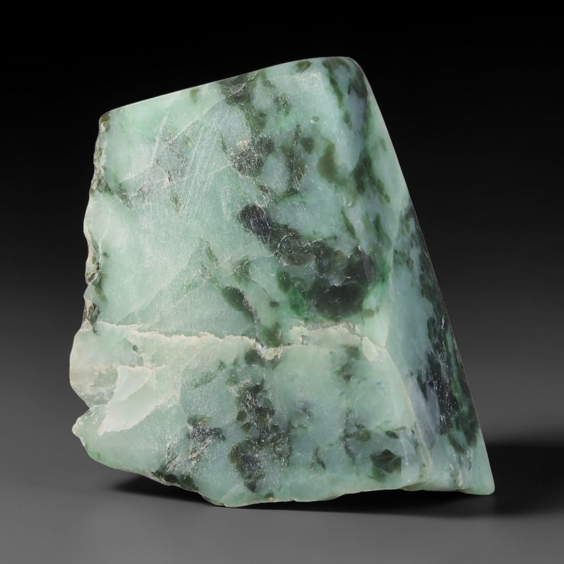 300ct Natural Type A Burmese Jadeite Jade Sliced Rough, 32FD: This specimen is a sliced rough block of natural Type A Burmese jadeite jade. The interior displays natural colour zoning with visible mineral veining and crystalline patterns typical of unprocessed j