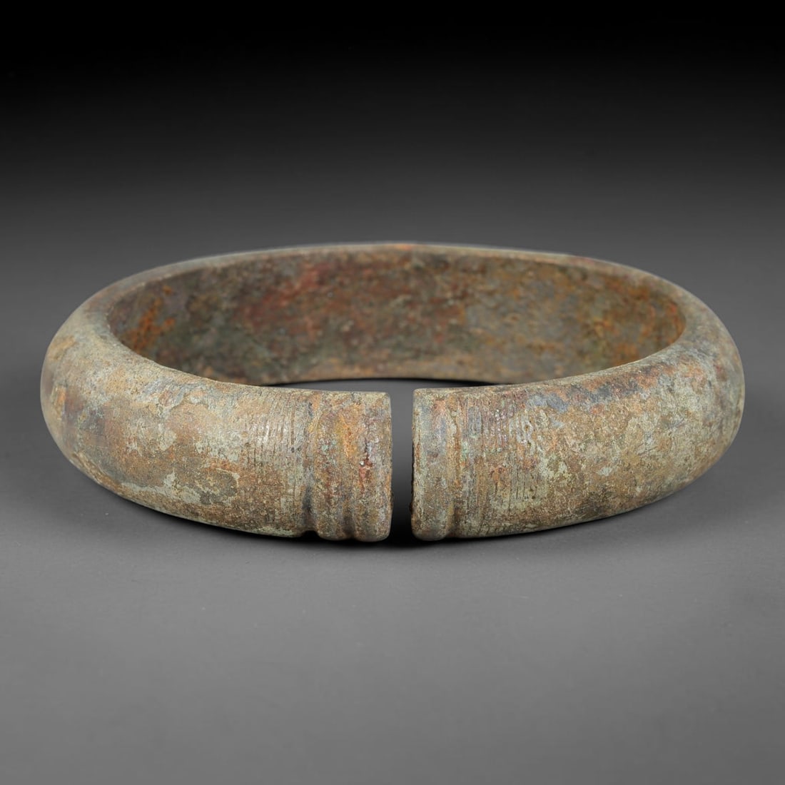 Ancient Roman Republic & Imperial Roman Bronze Open Armilla Bracelet (509 BCE-476 CE), 96AT: This antique solid bronze open cuff armilla bracelet originates from Roman Republic & Imperial Roman Culture, widely produced utilitarian and symbolic adornment worn by civilian women and awarded as m