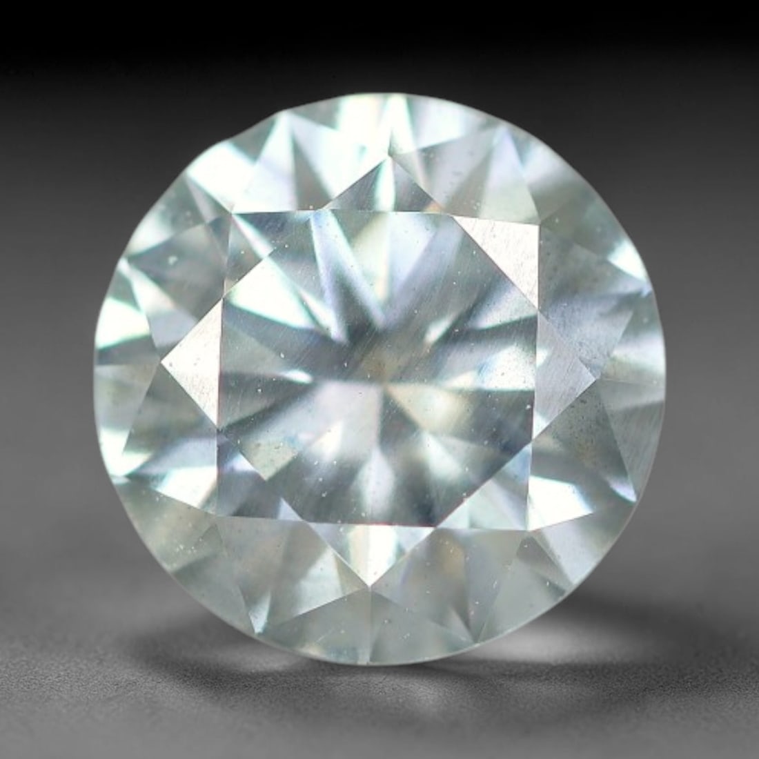 0.98 Carats Natural Cool White Moissanite Loose Gemstone, 22FP: This cool white moissanite holds dimension measurements of 6.5x4mm, delivering exceptional light dispersion that generates vivid rainbow sparkle across its fully transparent body, with faint microscop