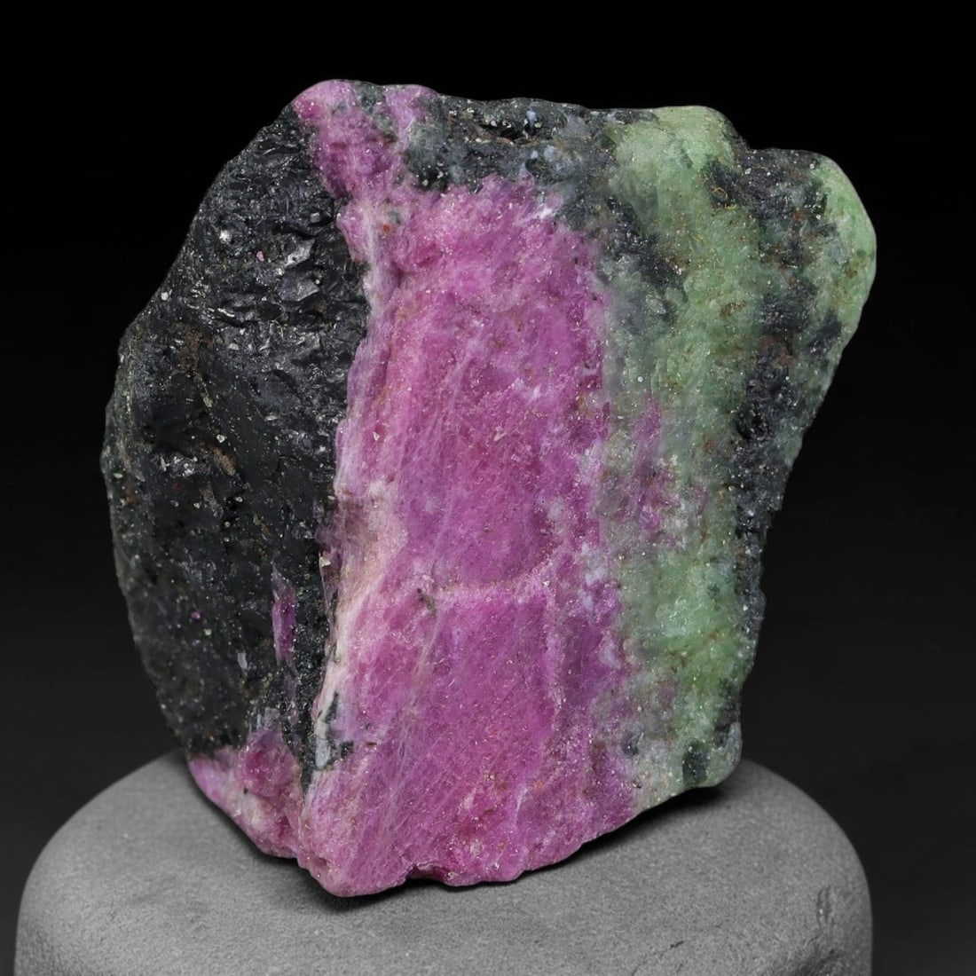 168ct Natural Tanzanian Ruby Zoisite Raw Rough Specimen Mineral Stone, 97FB: This unpolished mineral rough is natural ruby zoisite sourced from Tanzania, exhibiting distinct banded mineral segregation of vibrant green zoisite, magenta ruby crystals, and dark hornblende inclusi