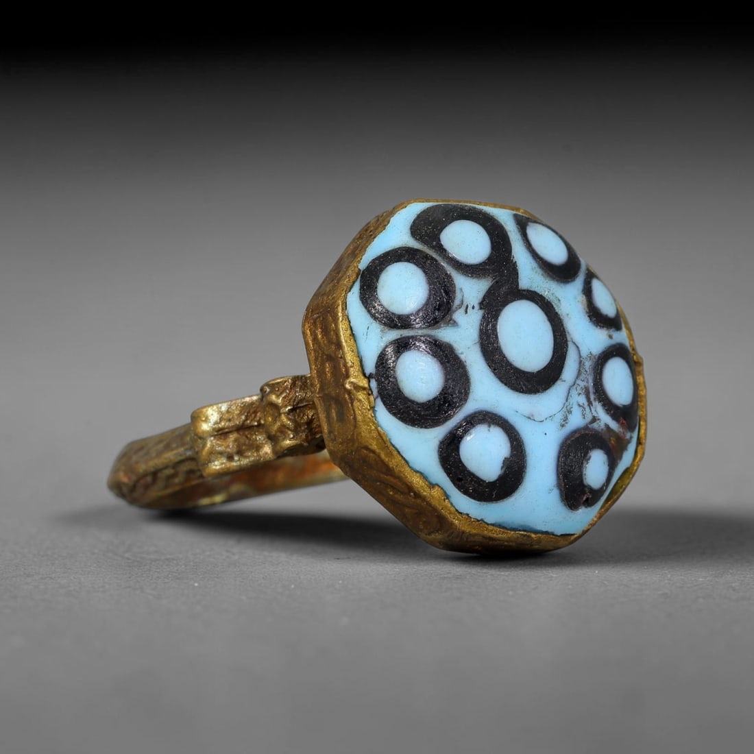 Antique Qajar Dynasty Copper Alloy Ring Set With Banded Glass Bead Cabochon, 51AC: Historic wearable signet ring crafted from textured copper alloy metal, sized to US ring size 9.5, originating from Qajar Persian artistic and adornment traditions of late medieval Iran. Copper alloy 