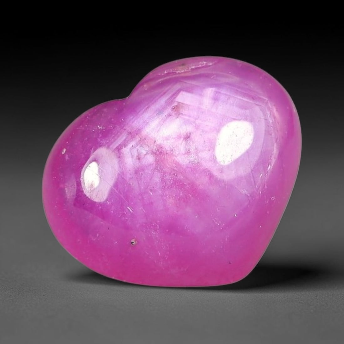 4.44 Carats Natural Mozambique Hot Pink Ruby Loose Gemstone, 54FE: This heart shaped Mozambique ruby cabochon measures 11x9x4mm, showcasing a vivid saturated hot pink body paired with stunning natural hexagonal crystal growth banding that forms a distinct geometric l