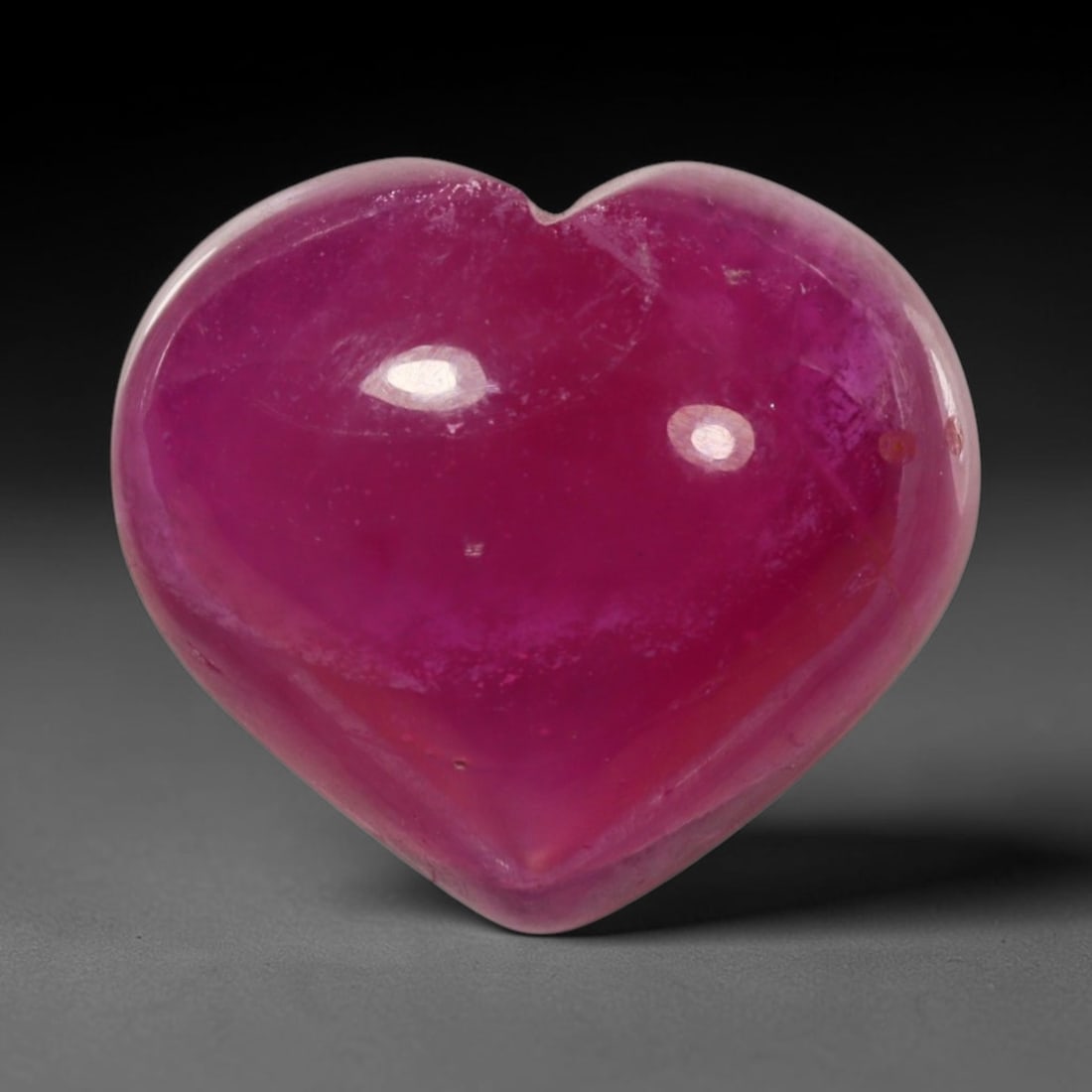 12.40ct Natural Mozambique Hot Pink Ruby Loose Gemstone, 79BP: This heart shaped Mozambique ruby cabochon measures 13.7x12.1x7.2mm, showcasing a vivid saturated hot pink body paired with stunning natural hexagonal crystal growth banding that forms a distinct geom