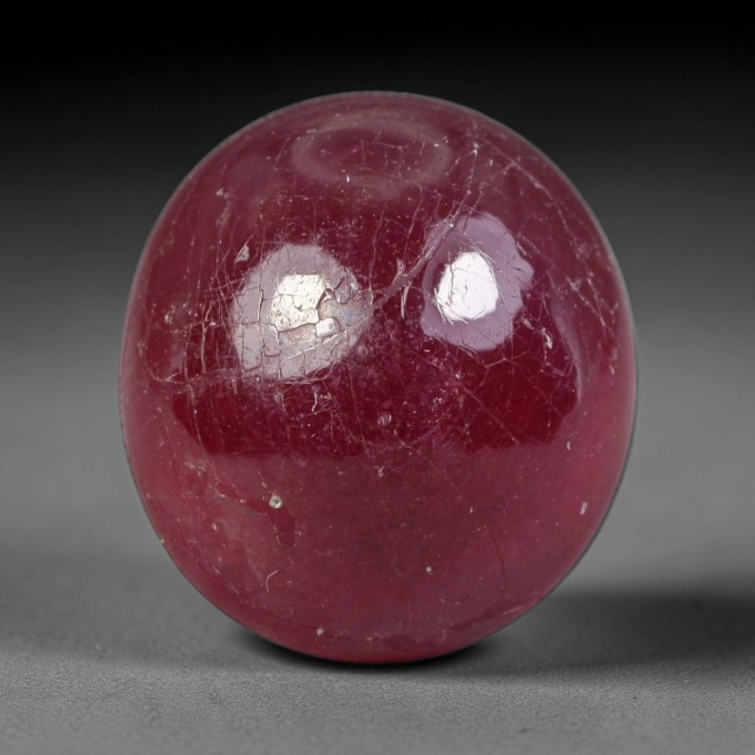 6.63ct Natural Mozambican Deep Crimson Red Ruby Cabochon Loose Gemstone, 22AS: This smoothly polished cabochon ruby holds a rich deep crimson red body hue, covered with fine natural surface fracturing and tiny scattered mineral specks across its domed polished surface within its