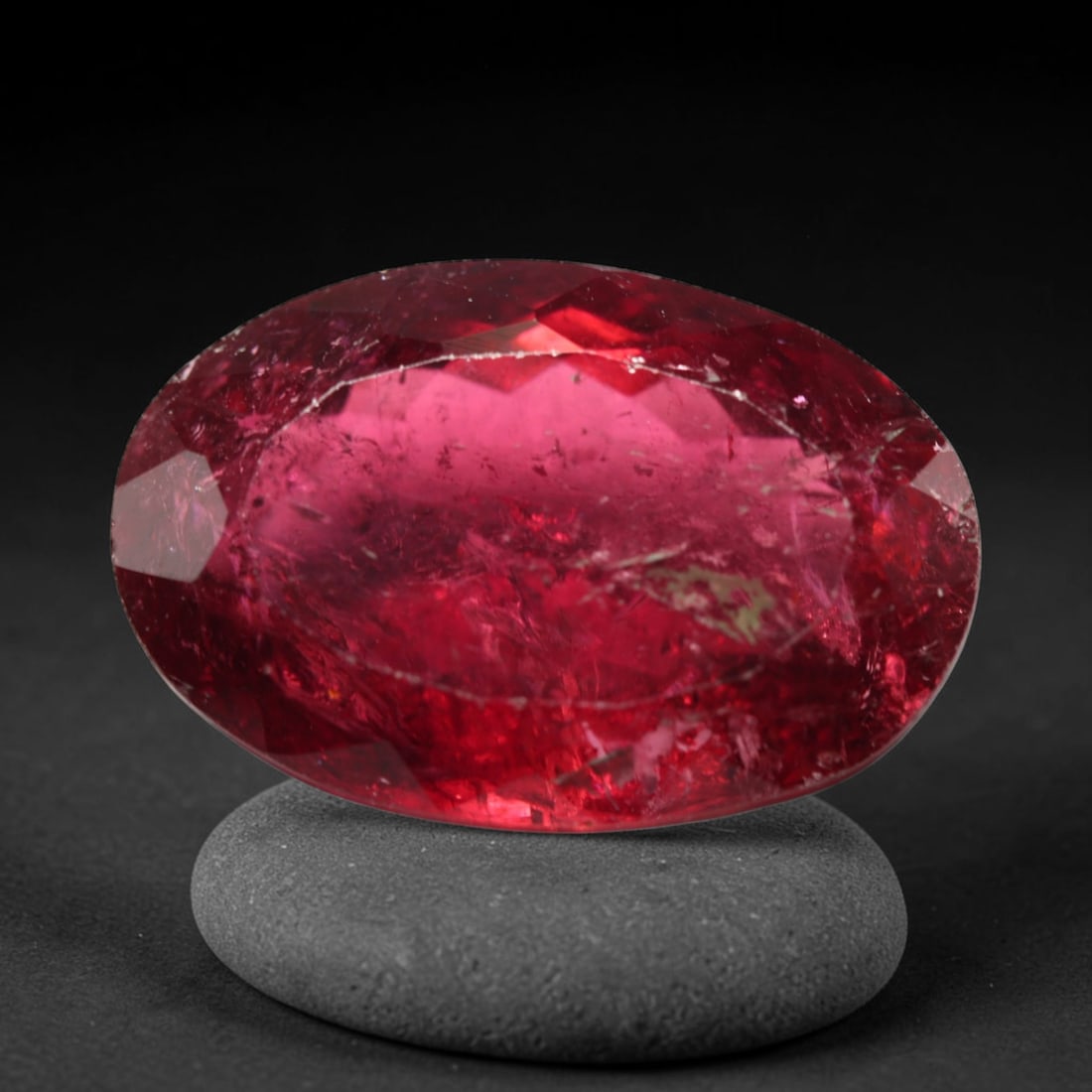 14.43ct Natural Mozambican Rubellite Tourmaline Oval Faceted Loose Gemstone, 75BZ: This precisely cut oval faceted gemstone is natural rubellite tourmaline sourced from Mozambique. It showcases striking saturated crimson-red colour throughout the crystal matrix, with distinct natura