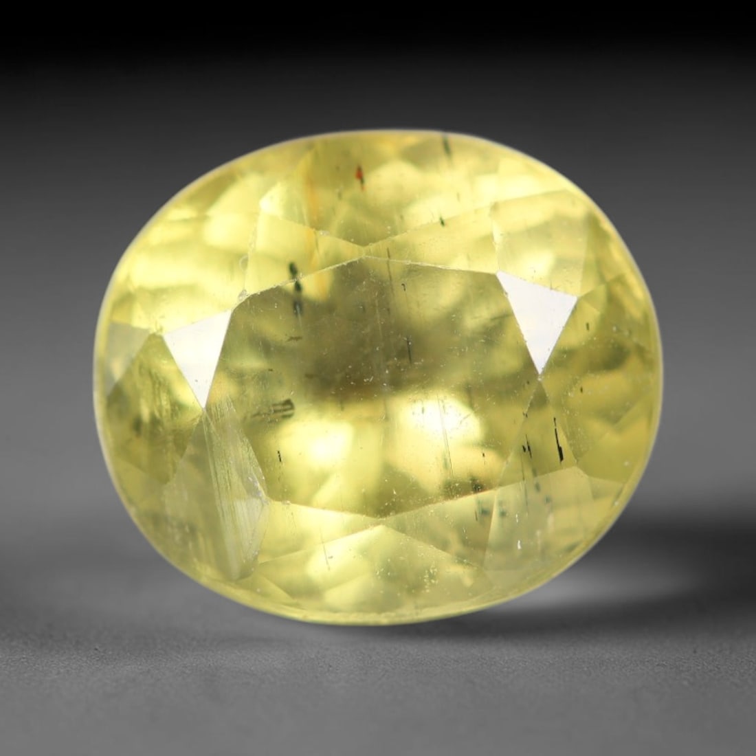 2.35ct Natural Mexican Lemon Yellow Faceted Apatite Loose Gemstone, 83AR: This expertly faceted yellow apatite holds translucent pale lemon yellow crystal structure with faint tiny internal mineral specks and subtle fine linear markings visible beneath its precisely polishe