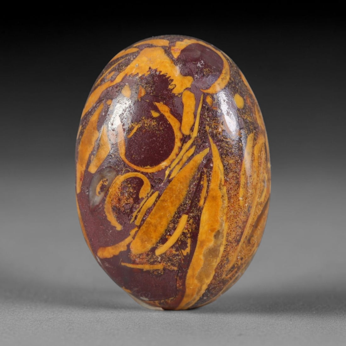 13.3ct Natural Mariam Jasper (Calligraphy Stone) Cabochon Loose Gemstone, 5AK: This fully polished Mariam Jasper, widely referred to as Calligraphy Stone, features deep plum base matrix interlaced with intricate golden ochre fossilized mineral veining that creates natural brushs