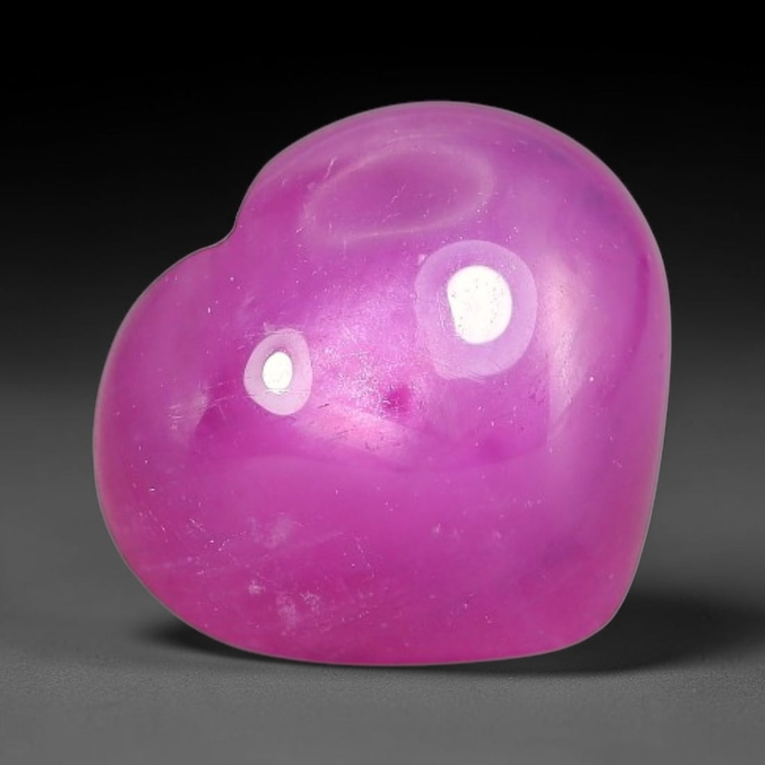 5.16 Carats Natural Mozambique Hot Pink Ruby Loose Gemstone, 49FE: This heart shaped Mozambique ruby cabochon measures 10.6x9.4x5.1mm, showcasing a vivid saturated hot pink body paired with stunning natural hexagonal crystal growth banding that forms a distinct geome