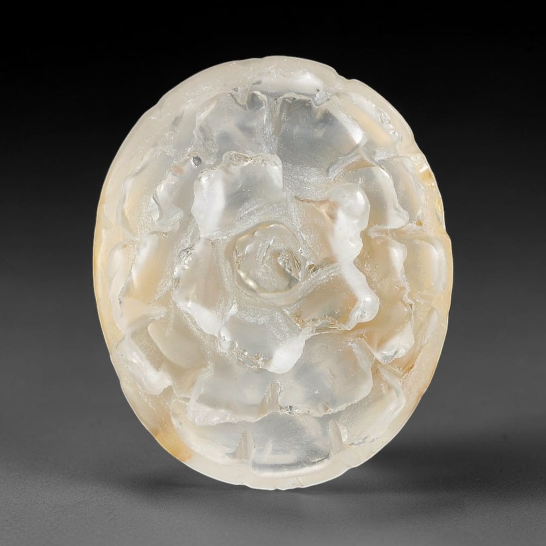 Natural Brazilian Phantom Quartz Hand Carved Floral Gemstone, 25BV: This hand-carved floral specimen is crafted from natural phantom quartz. Intricate layered floral detailing wraps across the stone's surface, while translucent quartz matrix reveals subtle internal ph