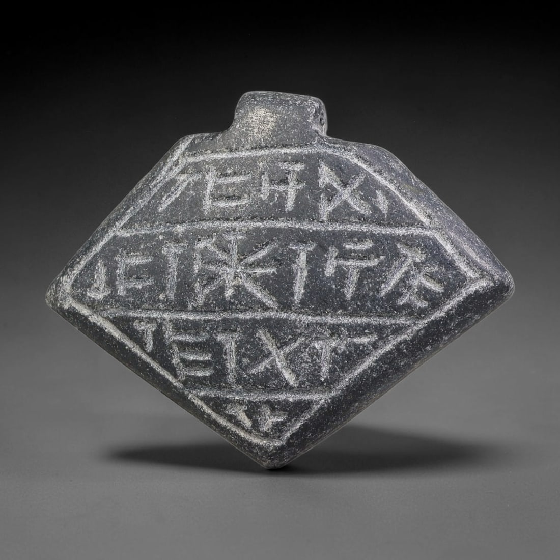 Vintage Uruk Revival Carved Stone Cuneiform Talisman Pendant Plaque, 94FK: This vintage pendant is hand-carved from dark mineral stone, designed in revival style inspired by ancient Uruk glyptic traditions. The surface features neatly arranged horizontal bands of stylized cu