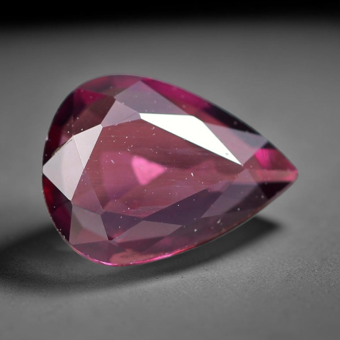 1.02ct Natural Tanzanian Rhodolite Grape Garnet Faceted Loose Gemstone, 93BF: This expertly faceted grape garnet, a scarce saturated purple-magenta rhodolite variant, features transparent crystal structure dotted with faint microscopic mineral specks within its precisely cut re