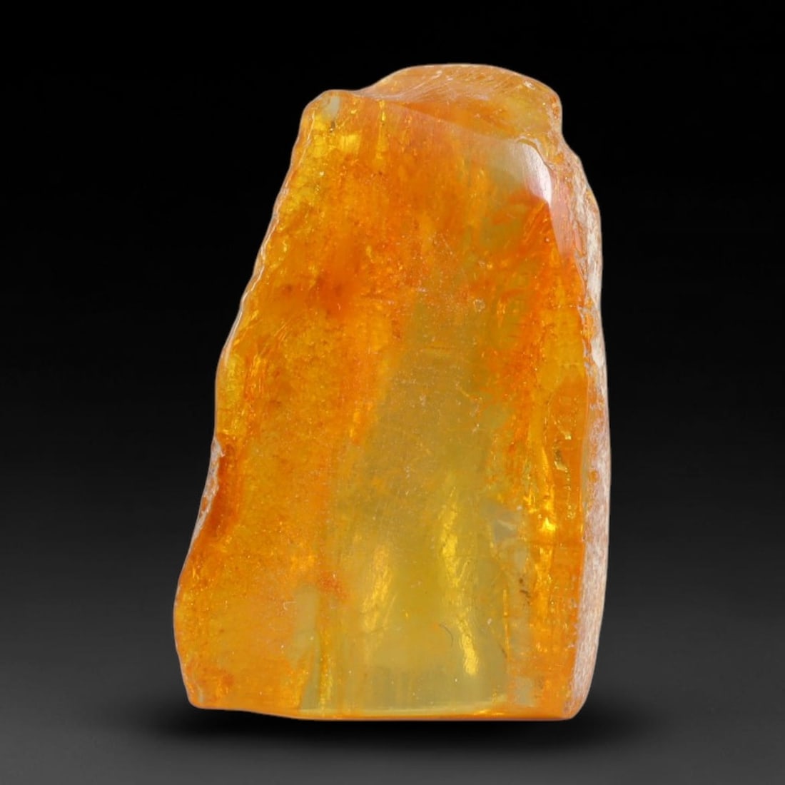 11.65ct Natural Baltic Polished Loose Freeform Amber Gemstone, 74AT: This smoothly polished freeform amber piece carries warm translucent organic clarity with fine natural fossil flecks and tiny mineral inclusions suspended throughout its 25x15mm flowing unstructured s