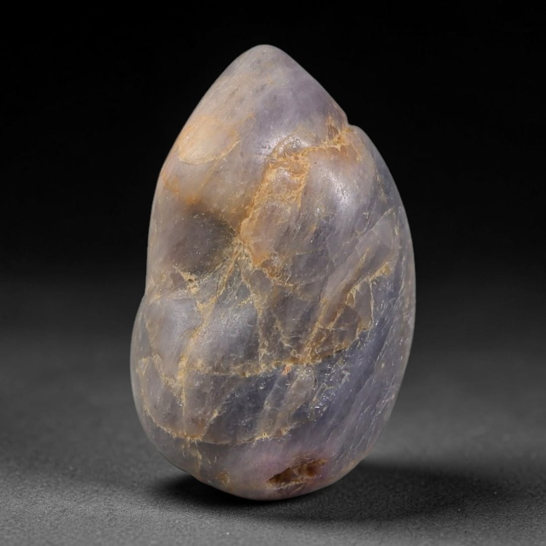 28.92ct Natural Unheated Sri Lankan Purplish Blue Sapphire Rough, 55FC: This natural corundum rough is an unheated purplish blue sapphire sourced from Sri Lankan alluvial gem deposits, featuring an irregular natural native form with residual pale yellow-brown mineral matr