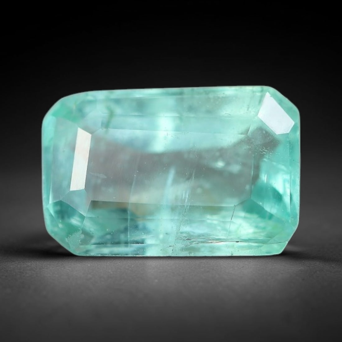 1.28 Carats Natural Zambian Green Emerald Loose Gemstone, 5FP: This green Zambian emerald holds smooth even saturation with subtle faint natural internal markings lending authentic organic character, measured at 8x5.3x3.8mm, its calm cool green tone delivers unde