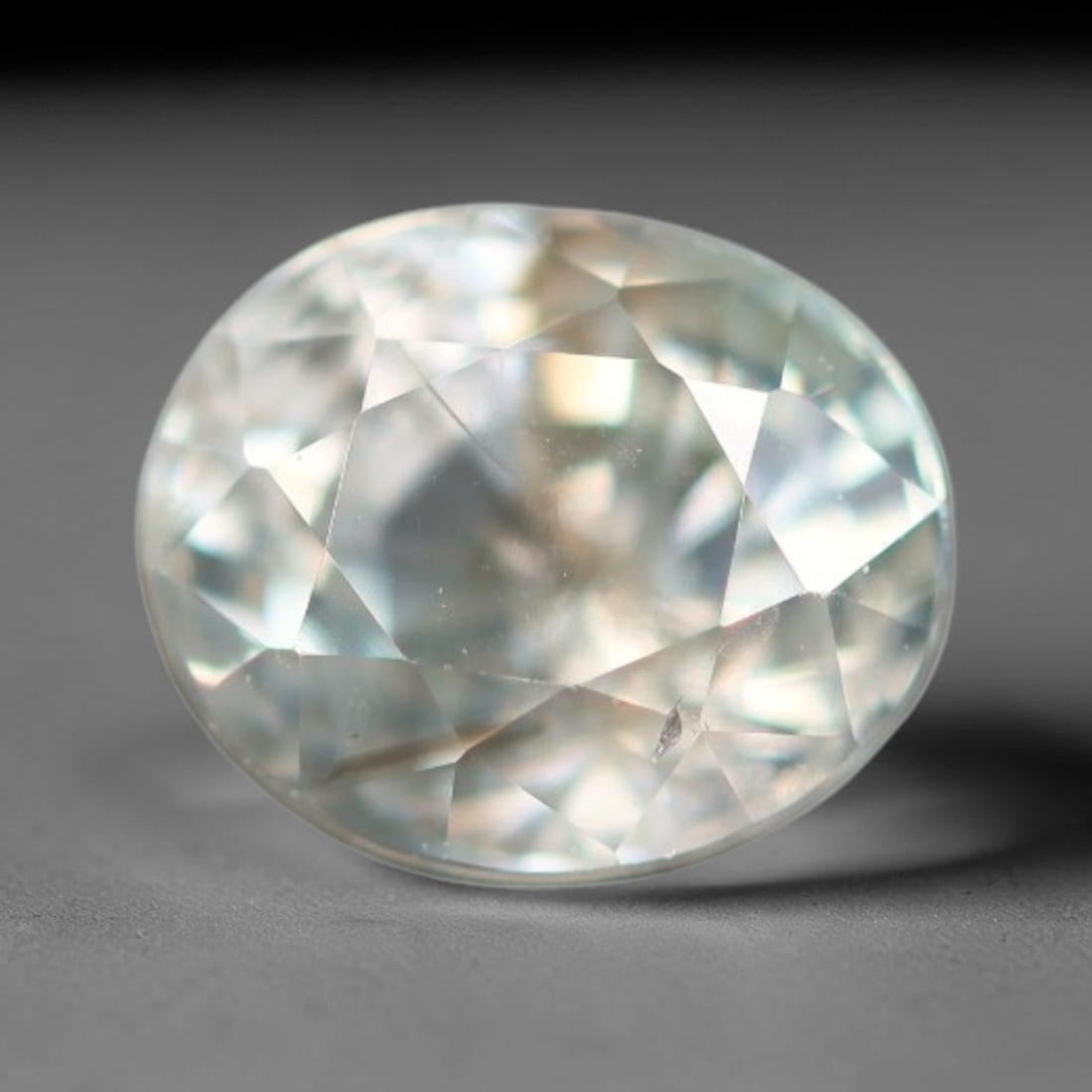 1.03ct Natural Cambodian White Zircon Loose Gemstone, 4BA: This fully polished Cambodian white zircon displays a crisp colorless transparent crystal body with faint microscopic mineral specks scattered within its high-refraction interior, measured at calibrat