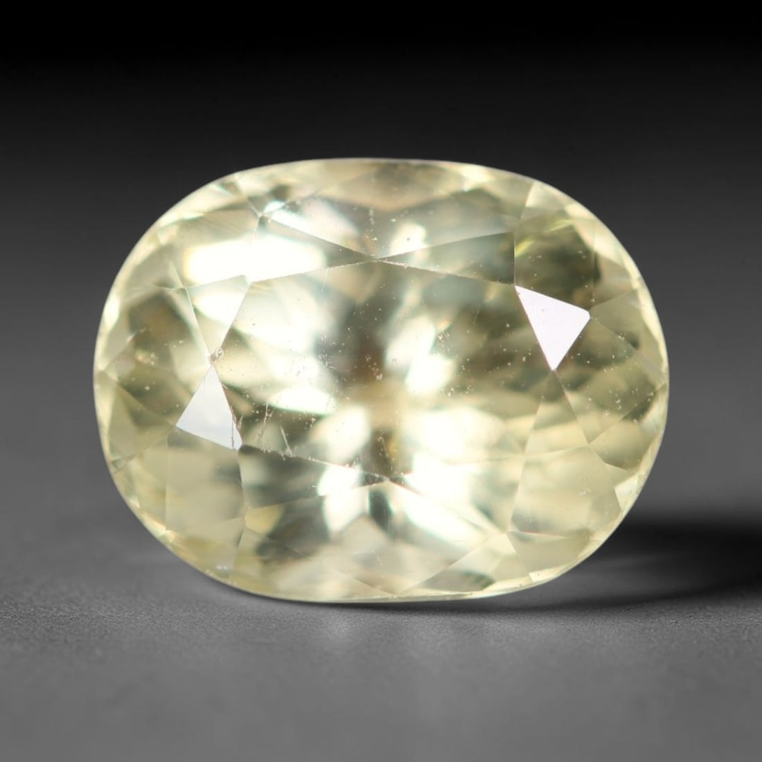 2.06ct Natural Mexican Lemon Yellow Faceted Apatite Loose Gemstone, 89AR: This expertly faceted yellow apatite holds translucent pale lemon yellow crystal structure with faint tiny internal mineral specks and subtle fine linear markings visible beneath its precisely polishe