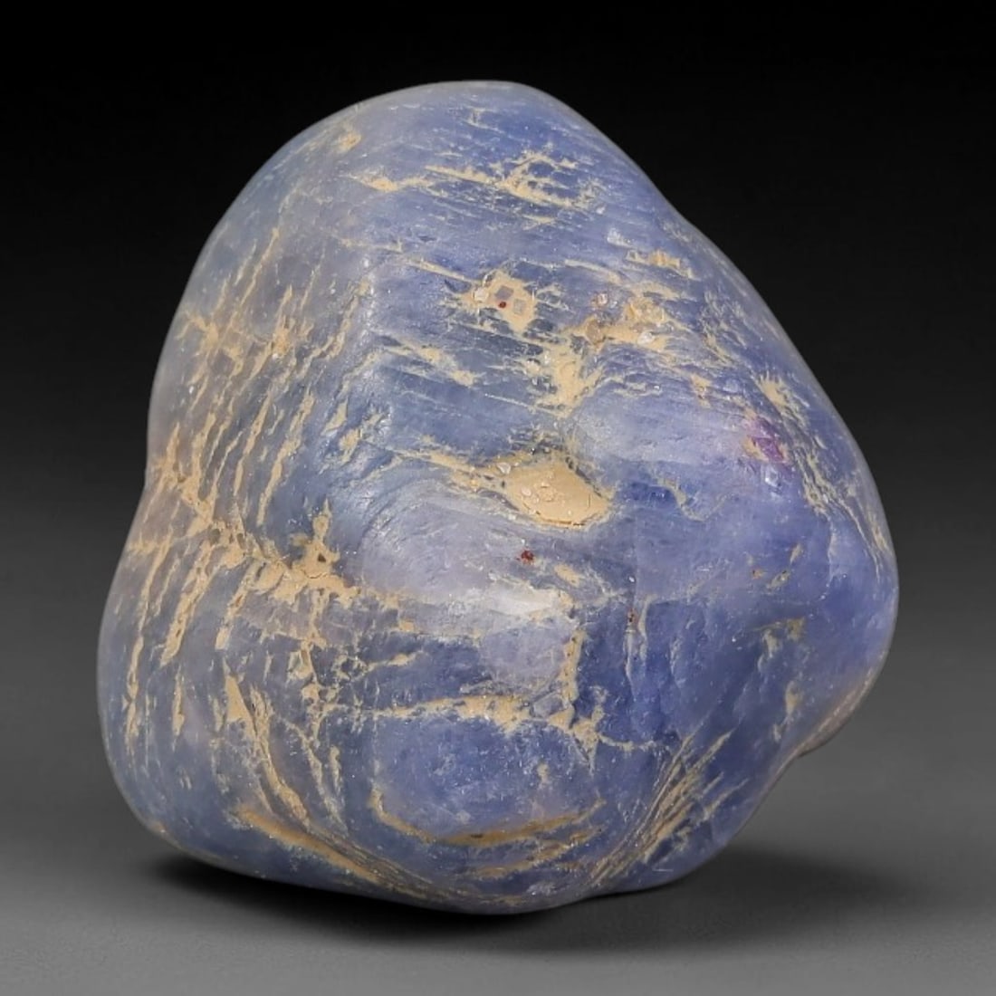 34.87ct Natural Unheated Sri Lankan Purplish Blue Sapphire Rough, 53FC: This natural corundum rough is an unheated purplish blue sapphire sourced from Sri Lankan alluvial gem deposits, featuring an irregular natural native form with residual pale yellow-brown mineral matr