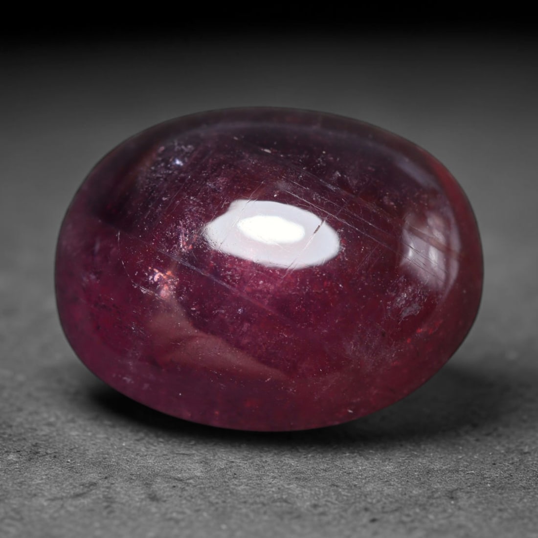 14.30ct Natural Madagascar Ruby Oval Cabochon Loose Gemstone, 62BY: This smoothly polished oval cabochon is natural ruby originating from Madagascar. It exhibits rich deep red colouration throughout the crystal matrix, with visible natural mineral veining, fine crysta