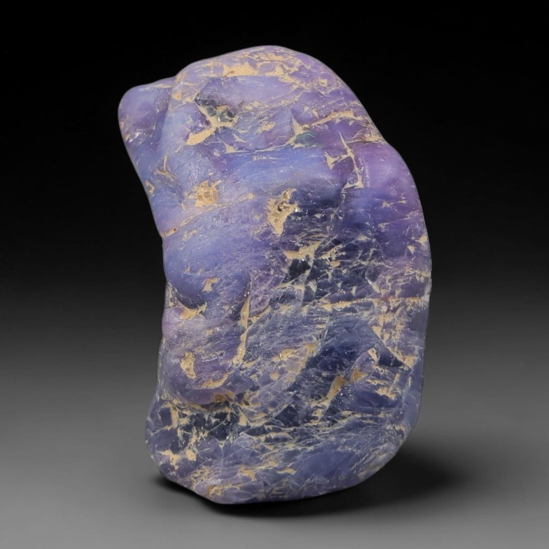 33.93ct Natural Unheated Sri Lankan Purplish Blue Sapphire Rough, 42FC: This natural corundum rough is an unheated purplish blue sapphire sourced from Sri Lankan alluvial gem deposits, featuring an irregular natural native form with residual pale yellow-brown mineral matr
