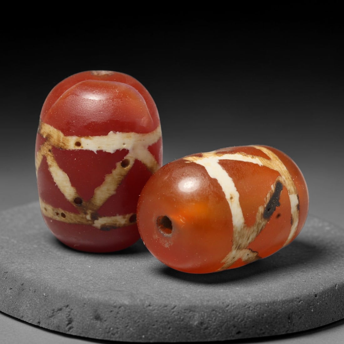 Ancient Medieval Burmese Pagan & Ava Kingdoms Etched Carnelian Barrel Beads (849-1555 CE), 39FY: This pair of antique etched carnelian barrel beads originates from the Medieval Burmese Pagan & Ava Kingdoms, whose etched carnelian bead craft continued to produce trade specimens circulated widely t