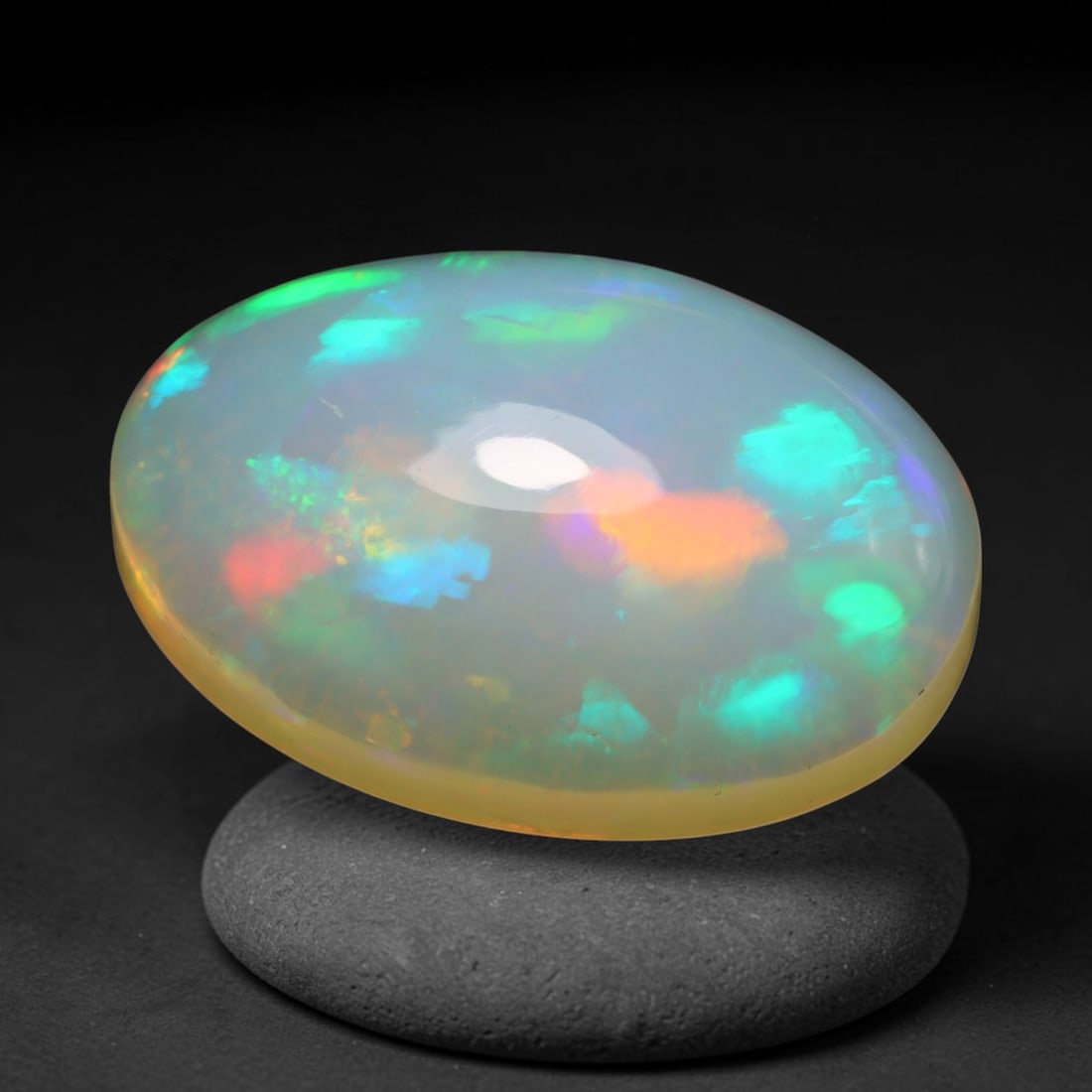 7.85ct Natural Ethiopian Welo Opal Cabochon Loose Gemstone, 53BY: This smoothly polished cabochon is genuine natural Ethiopian Welo opal. The translucent base hosts vivid multi-coloured play-of-colour, displaying dynamic flashes of multi color that shift as the view