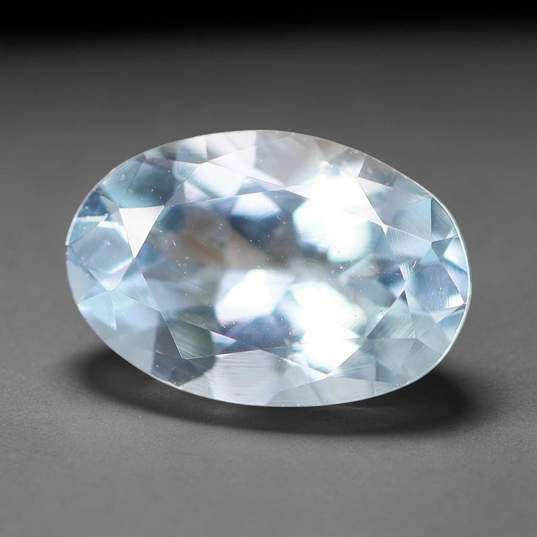 1.08ct Natural Brazilian Sky Blue Faceted Aquamarine Loose Gemstone, 2BF: This precisely faceted aquamarine boasts clear translucent pale sky blue body tone with subtle thin mineral needle and tiny scattered crystalline specks visible within its polished reflective planes i