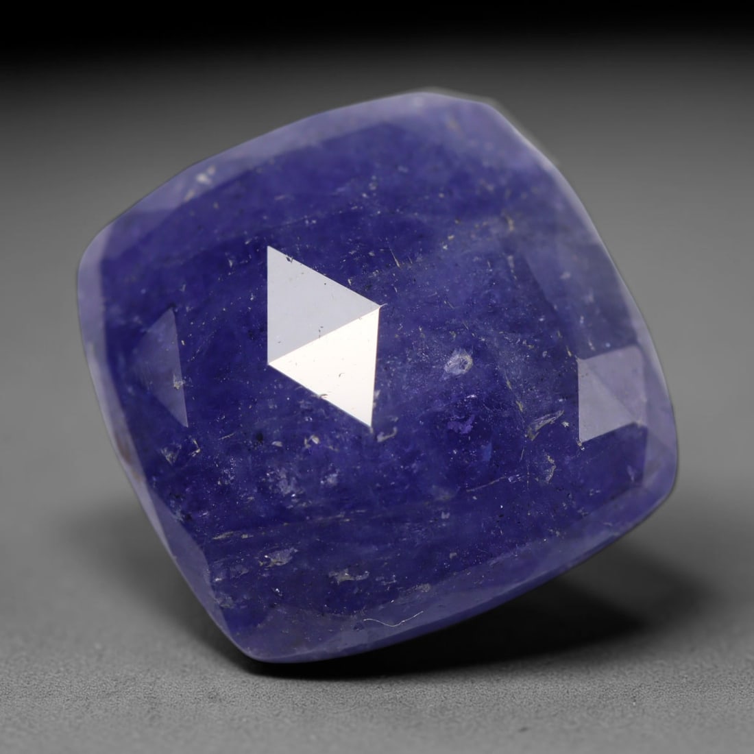 34.67ct Natural Tanzanian Tanzanite Cushion Faceted Cabochon Loose Gemstone, 62BZ: This cushion-shaped faceted cabochon is natural tanzanite, originating from Tanzania, the sole global source of this exceptional gem variety. The stone displays rich deep violet-blue colour throughout