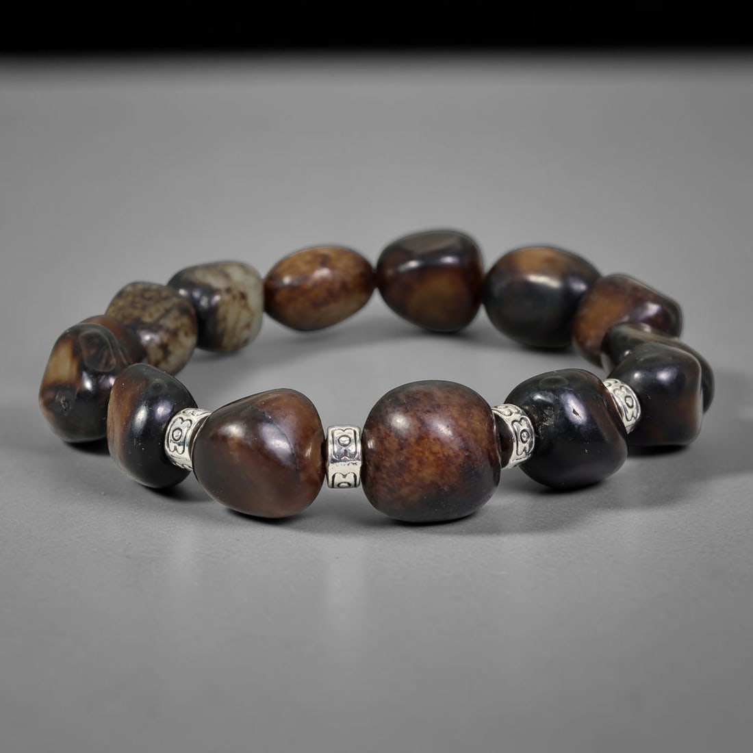 Natural Chinese Hetian Nephrite Jade Tumbled Beaded Bracelet, 31FJ: Features polished natural Chinese Hetian nephrite jade freeform tumbled beads paired with decorative accent elements. Approximate bead size 14mm, arranged into a flexible wearable strand. Each bead ca