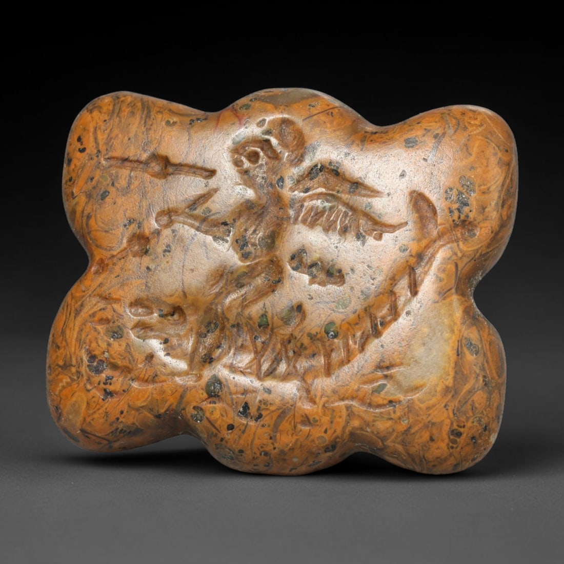 Ancient Roman Fossil Stone Intaglio Bead (c.1st-4th Century CE), 73EC: This antique fossil-bearing variegated stone intaglio bead originates from Ancient Roman civilisation, renowned for hardstone glyptic craft used to create wearable talismanic jewellery. The carved fac