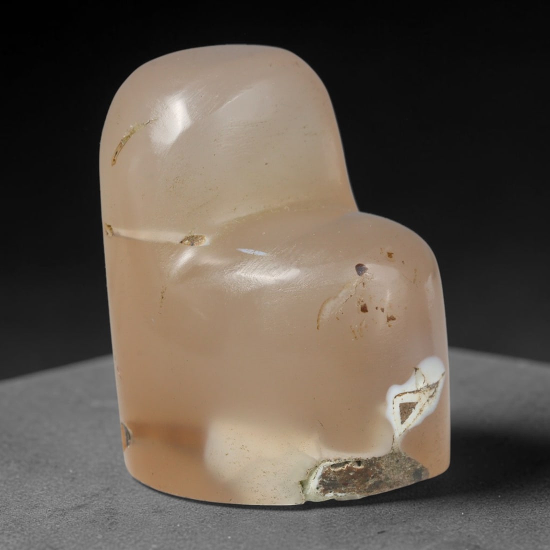 Ancient Medieval Mamluk Period Agate Talisman (c.13th-16th Century CE), 52EC: This solid talismanic carving is fashioned from natural pale agate with subtle white natural inclusions. The smooth organic shape bears soft surface wear and minor ancient encrustations accumulated ov