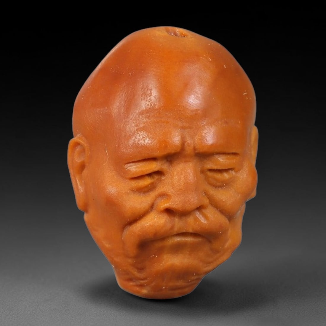 A Chinese Carved Natural Olive Nut Drilled Art Bead, 59BZ: Traditional craft bead carved from solid natural olive nut core, representing a classic miniature Chinese micro-carving folk art piece with a pre-drilled suspension bore integrated for easy threading 