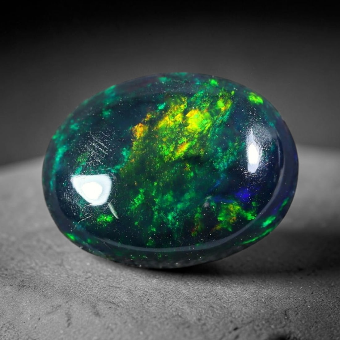 2.22ct Natural Ethiopian Welo Black Smoked Opal Cabochon Loose Gemstone, 37FX: This fully polished Ethiopian Welo opal features a dark smoked base with vivid, sweeping play-of-color shifting across its glossy dome surface, measured at 11x8x4mm. The black smoke treatment deepens 