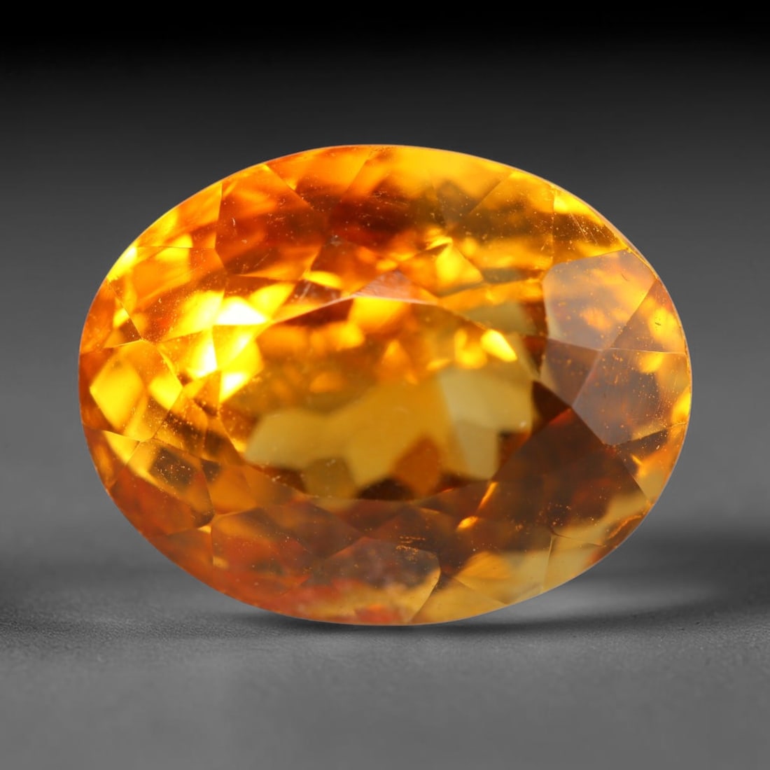 8.62ct Natural Brazilian Madeira Citrine Oval Faceted Loose Gemstone, 63BZ: This expertly cut oval faceted gemstone is natural Madeira citrine sourced from Brazil. It exhibits rich, saturated deep golden-orange tone characteristic of premium Madeira citrine, with crisp facets