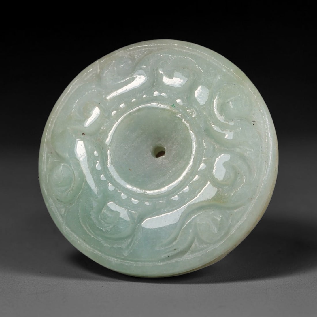 Natural Burmese Type A Jadeite Jade Carved Disc Pendant, 49BP: Artisan hand-carved untreated Burmese Type A jadeite jade circular disc pendant with a 26 mm diameter. The surface is adorned with detailed traditional relief carving finished with a smooth polished s
