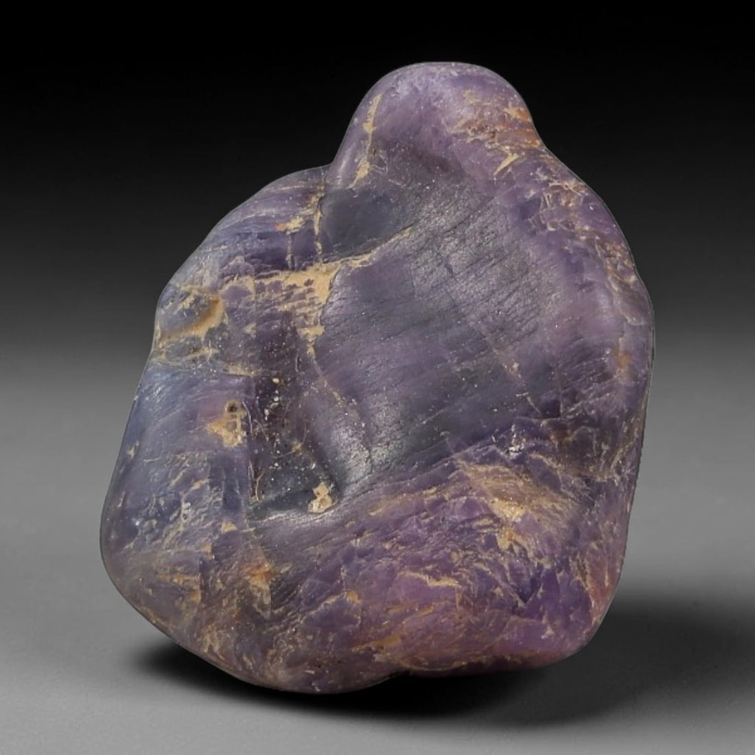 28.42ct Natural Unheated Sri Lankan Purplish Blue Sapphire Rough, 92FC: This natural corundum rough is an unheated purplish blue sapphire sourced from Sri Lankan alluvial gem deposits, featuring an irregular natural native form with residual pale yellow-brown mineral matr