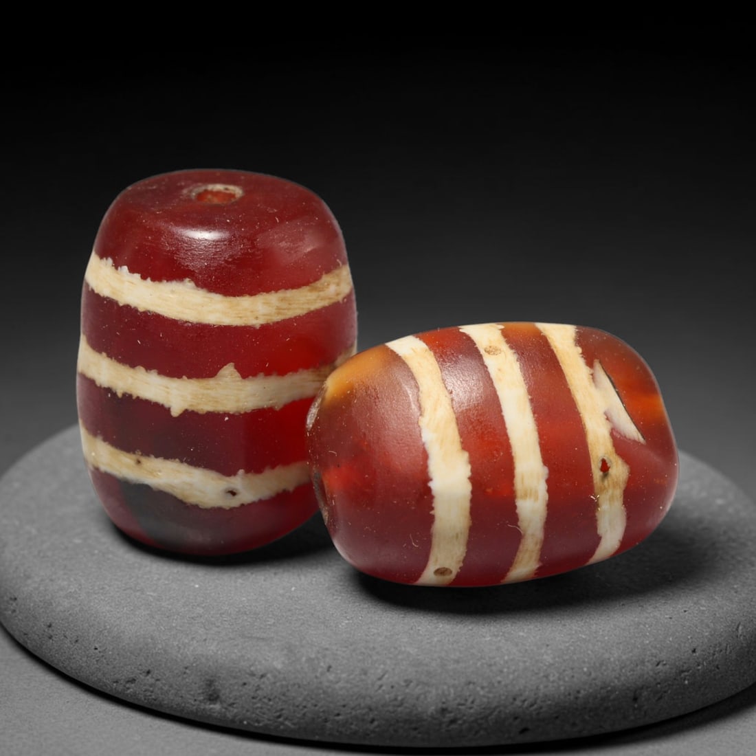 Ancient Medieval Burmese Pagan & Ava Kingdoms Etched Carnelian Barrel Beads (849-1555 CE), 34FY: This pair of antique etched carnelian barrel beads originates from the Medieval Burmese Pagan & Ava Kingdoms, whose etched carnelian bead craft continued to produce trade specimens circulated widely t