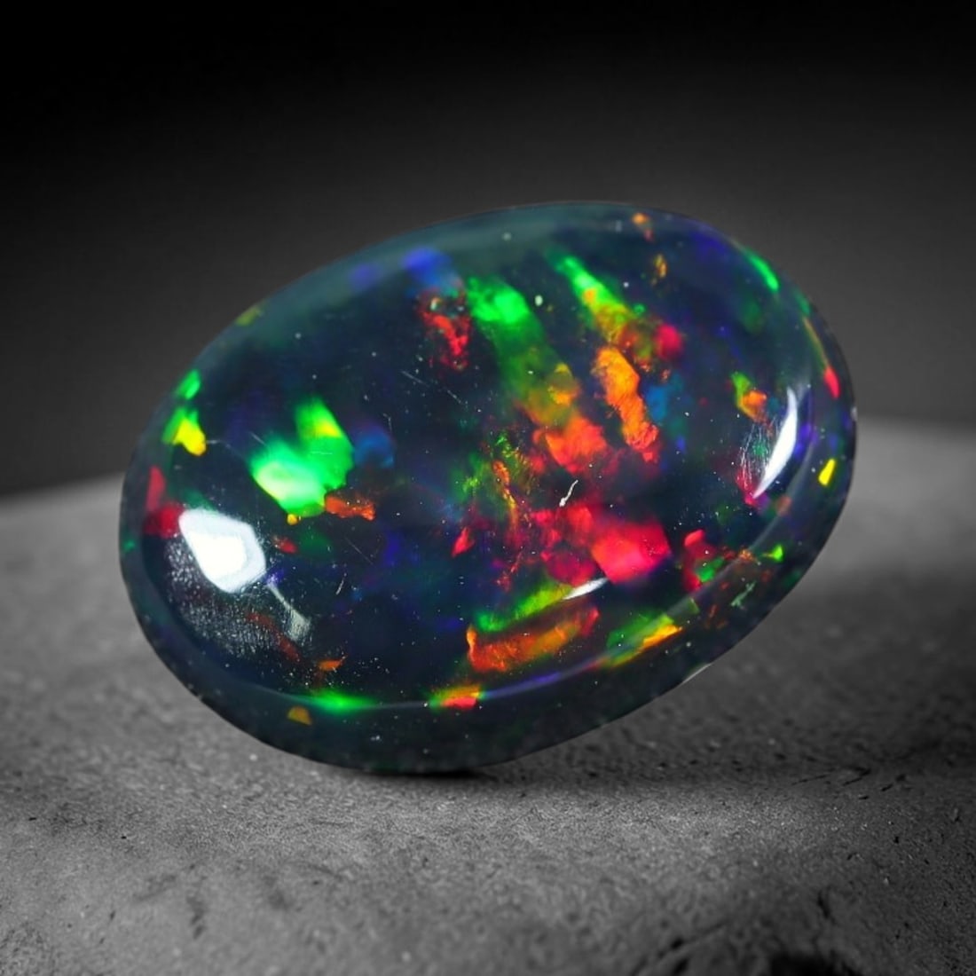1.70ct Natural Ethiopian Welo Black Smoked Opal Cabochon Loose Gemstone, 41FX: This fully polished Ethiopian Welo opal features a dark smoked base with vivid, sweeping play-of-color shifting across its glossy dome surface, measured at 11x8x3mm. The black smoke treatment deepens 