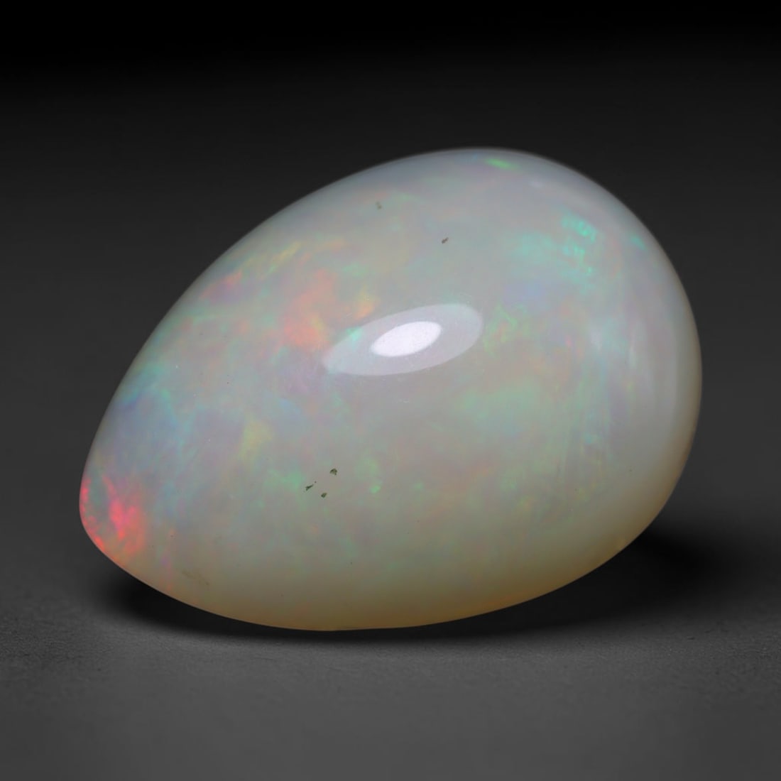 24.60ct Natural Ethiopian Welo Opal Cabochon Loose Gemstone, 68BY: This smoothly polished cabochon is genuine natural Ethiopian Welo opal. The translucent base hosts vivid multi-coloured play-of-colour, displaying dynamic flashes of multi color that shift as the view