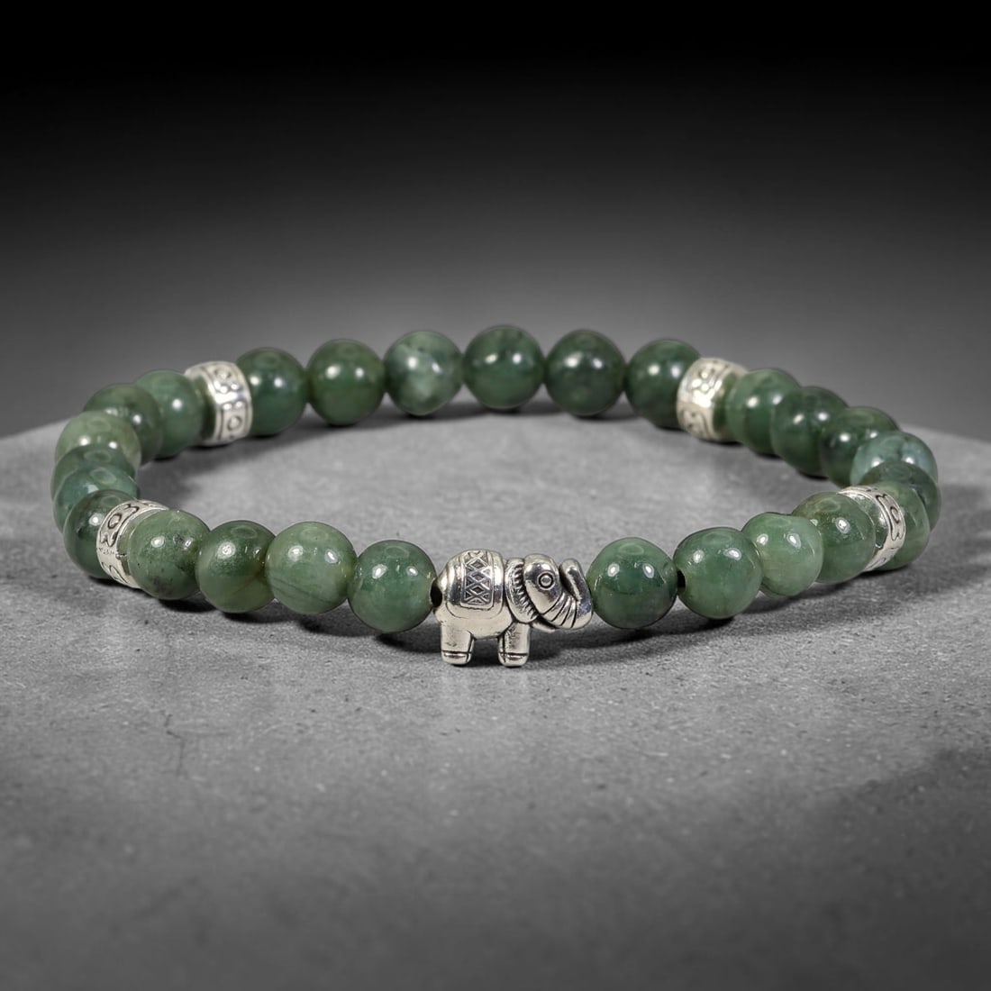 Natural Burmese Type A Jadeite Jade Stretch Bracelet with Antique Silver Charms, 98FV: Comfort elastic stretch bracelet composed of polished natural jadeite beads, fitted with decorative antiqued silver-toned spacers and feature charm. The beads exhibit soft natural tonal variations, st