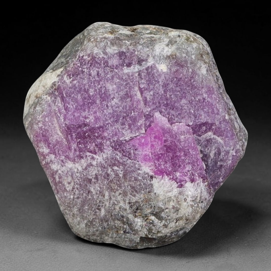 29.09ct Natural Mauritania Ruby Rough (Unheated), 48AT: Natural unheated corundum rough mined from Mauritanian gem deposits, featuring rounded irregular matrix form with a prominent concentrated patch of vivid magenta-pink ruby corundum set within pale tra