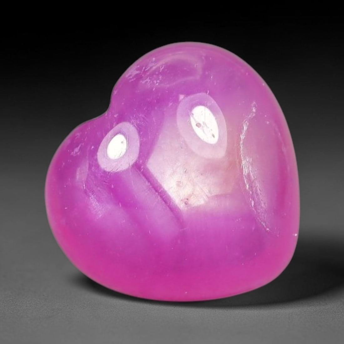 5.02 Carats Natural Mozambique Hot Pink Ruby Loose Gemstone, 52FE: This heart shaped Mozambique ruby cabochon measures 10x9.5x4.9mm, showcasing a vivid saturated hot pink body paired with stunning natural hexagonal crystal growth banding that forms a distinct geometr